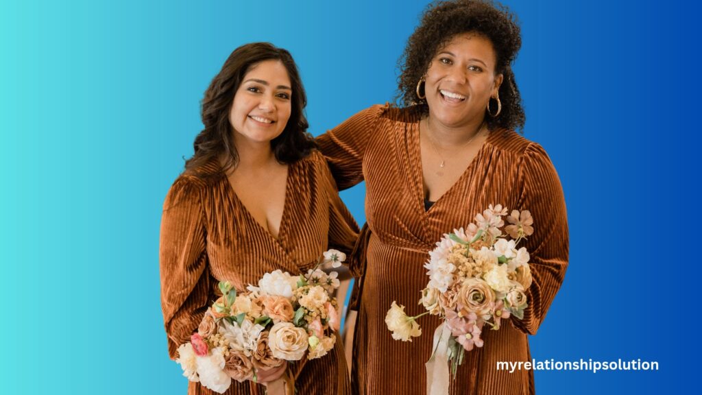 Bridesmaid and maid of honor holding flowers